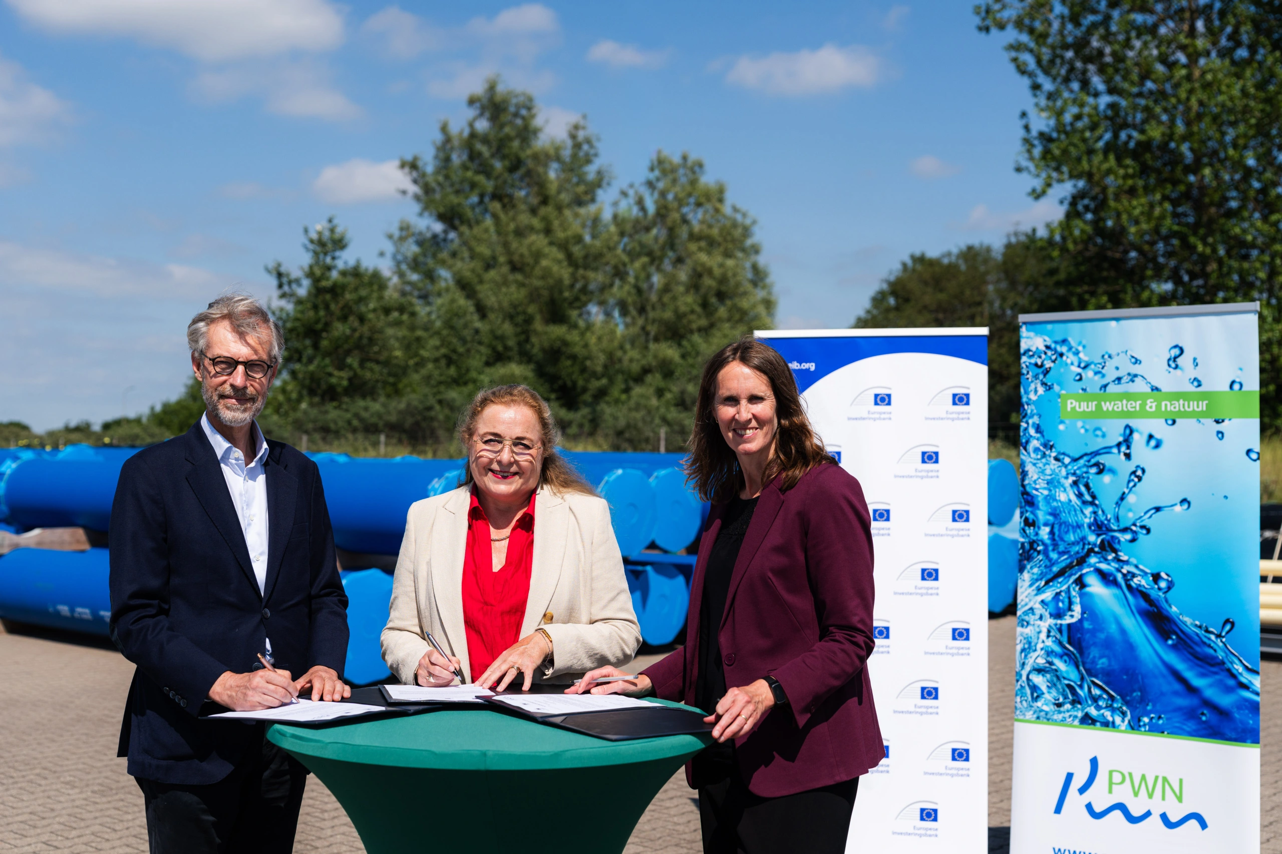 Robert de Groot (vicepresident EIB), Paulien Pistor (algemeen directeur PWN) en Ingelise de Boer (woordvoerder Europese Commissie) tekenen de overeenkomst tussen de EIB en PWN.